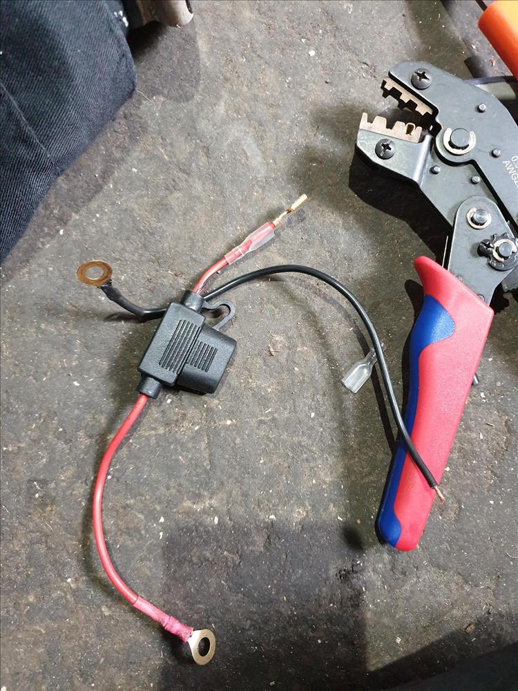 An electrical crimping tool and some associated wires on the floor of Pocketpete's garage