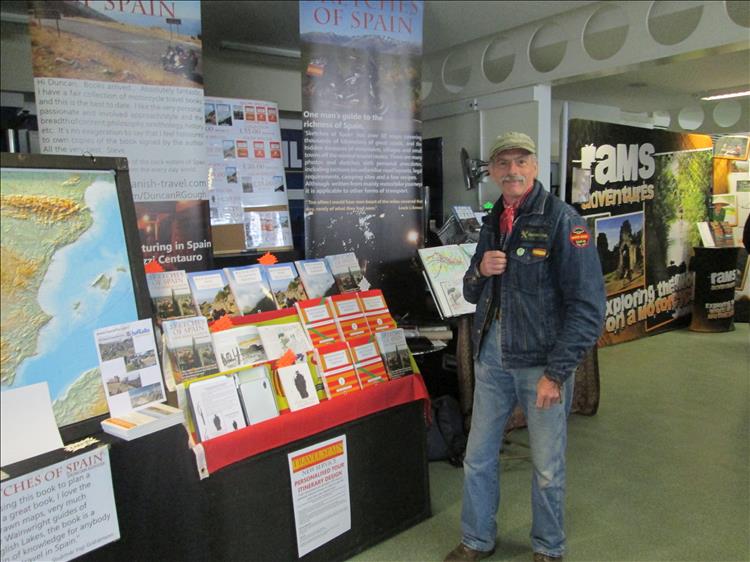 Duncan stands in front of his book selling display