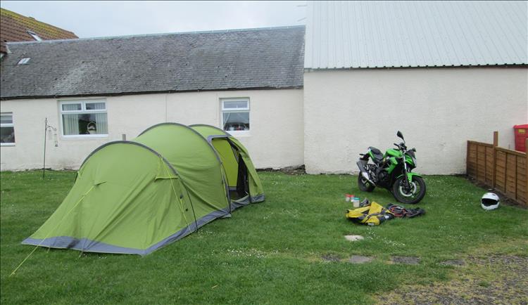 The tent next to a building at the Heads of Ayr Campsite