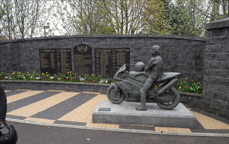 Joey Dunlop statue and a wall with records of his victories, the joey dunlop memorial