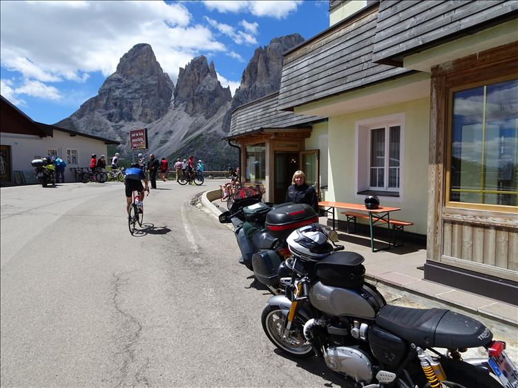 Motorcycles, towering rocky mountains, cyclists, a bar and Upt'North's wife in The Dolomites