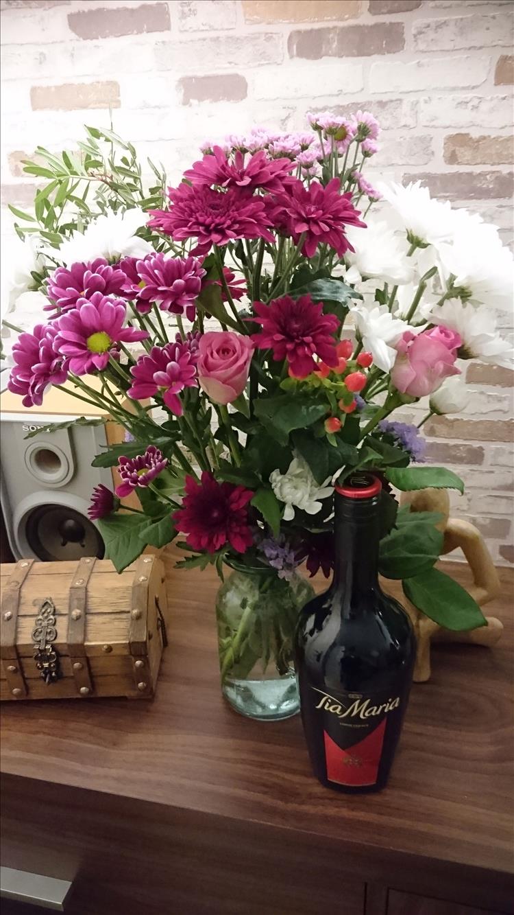 A bouquet of flowers and a bottle of tia maria from Sharon's daughter
