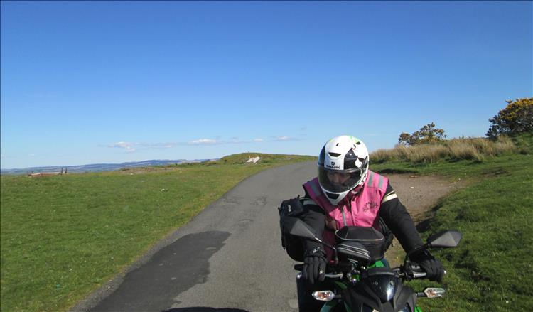 Sharon tentatively sits on the 250 on a narrow lane cresting the top of a steep hill