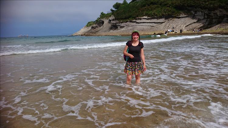 Sharon is paddling in the warm waters of the small cove