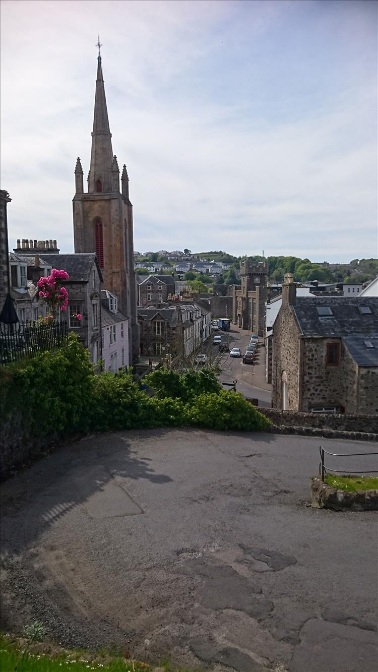 A tall church spire, a sharp corner and the steep hill of the serpentine road at Rothesay