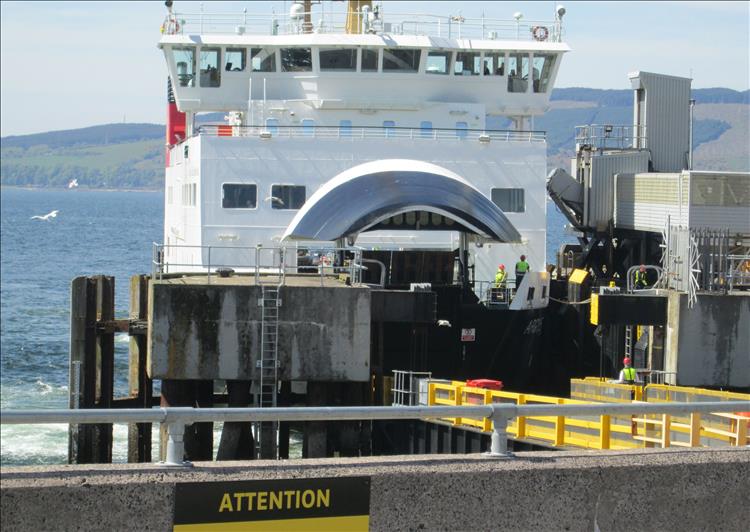 The ferry is port with the bow door open and offloading traffic