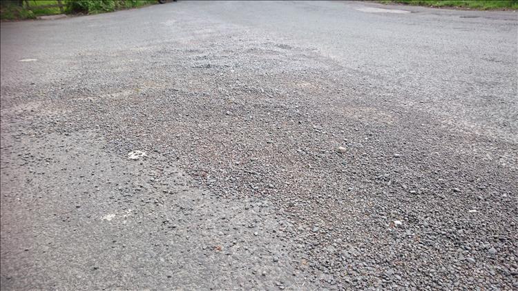gravel spread across the road on the outer radius of the corner