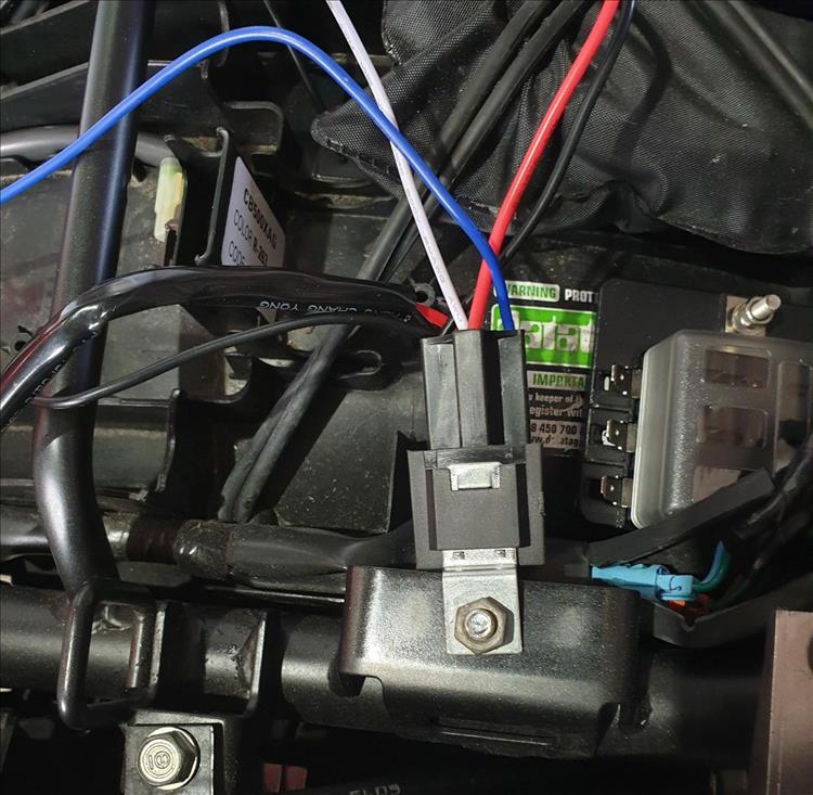 The relay is wired under the seat and mounted to the frame