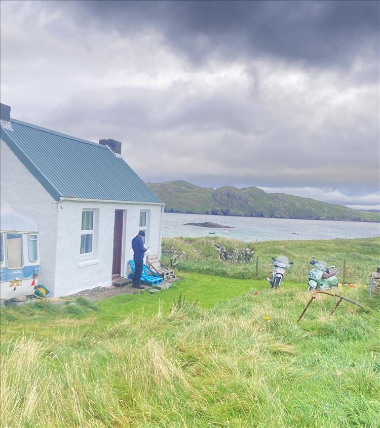 The small white building of the both is set in the wild and remote landscape of Lewis