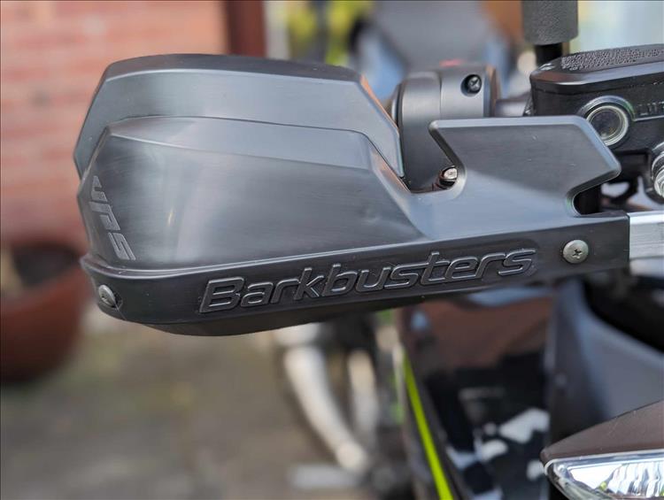 The barkbusters are metal protection with plastic deflectors around the levers on the bike