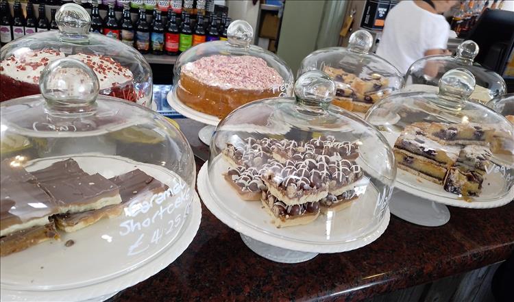 A display of cakes under glass covers at the cafe in Dalwhinnie