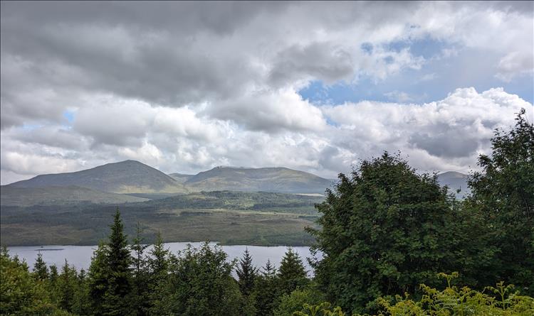 A loch, trees, mountains and clouds make for an impressive scene at Glengarry