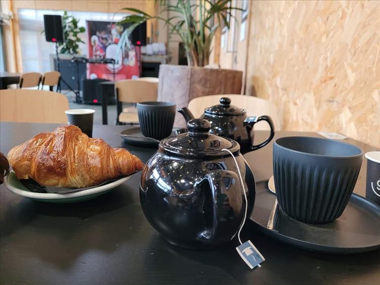 Croissant, tea pot, trndy cups and a modern cafe in Liverpool