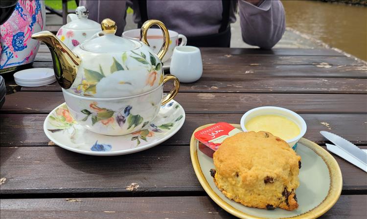 A pot of tea, a scone, jam and cream at the marina in Cheshire