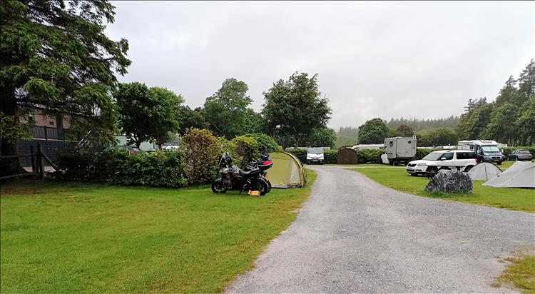 The motorcycles and the tent in the heavy rain at the campsite in Fort William