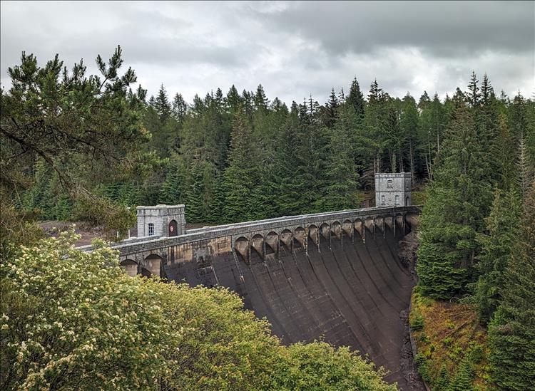 Trees, mountains and valleys then the huge concrete dam at Laggan