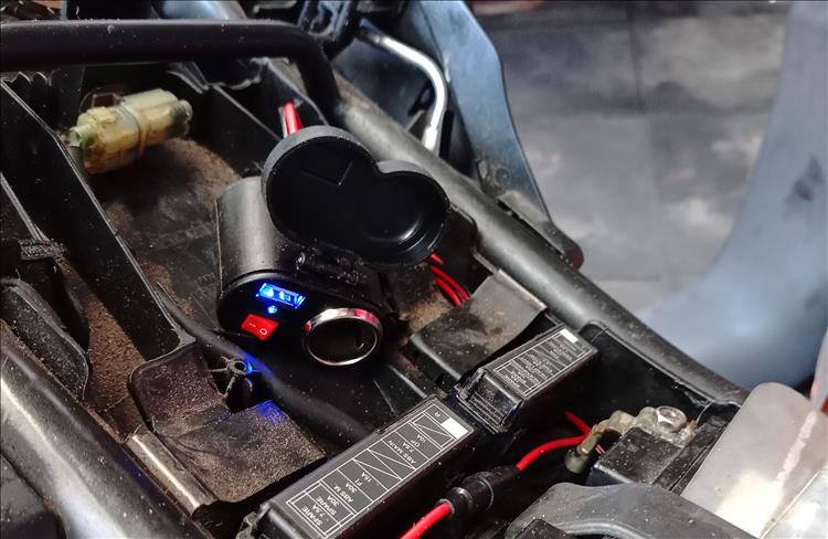 The new charger is positioned under the seat close to the battery this time