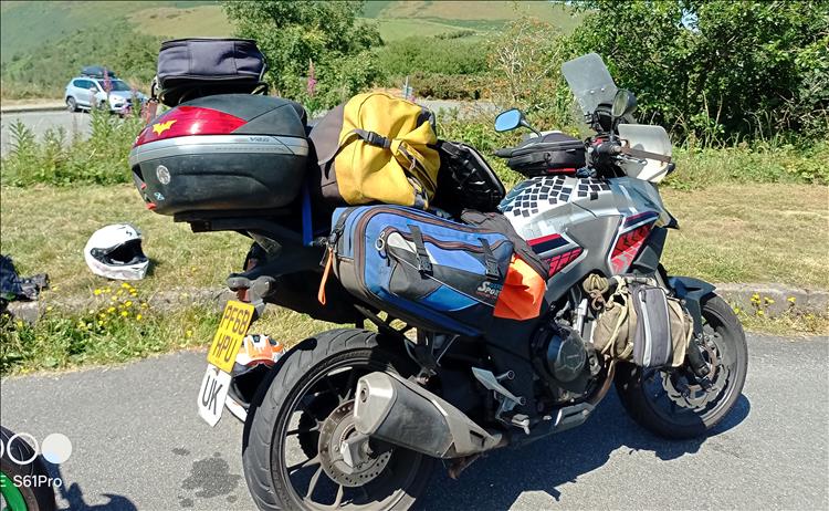 The dirty old CB500X covered with bags on tour around wales