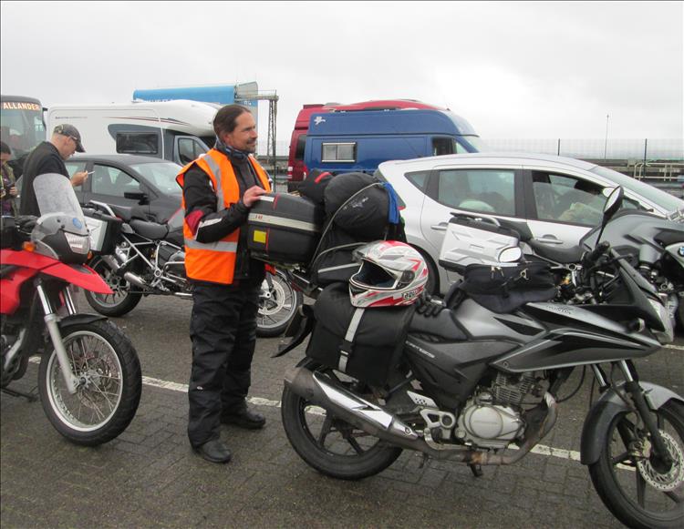 Ren almost smiling stood next to his 125 and looking a bit camp