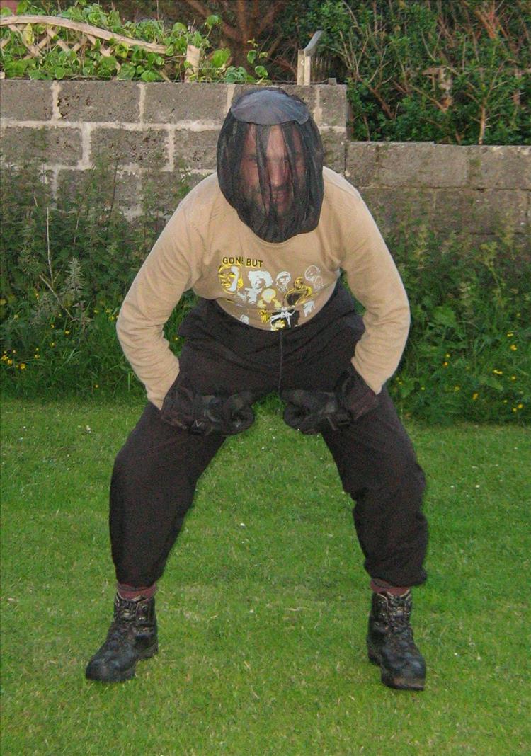 Ren has a midge net on his head and posing like a hero but looking stupid