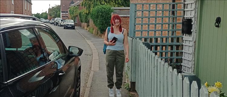 Sharon smiling while walking around the pretty village of Long Itchington