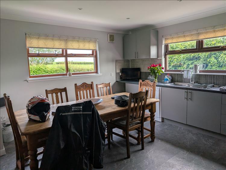 A smart and clean kitchen with large table and a few pleasant welcome gifts