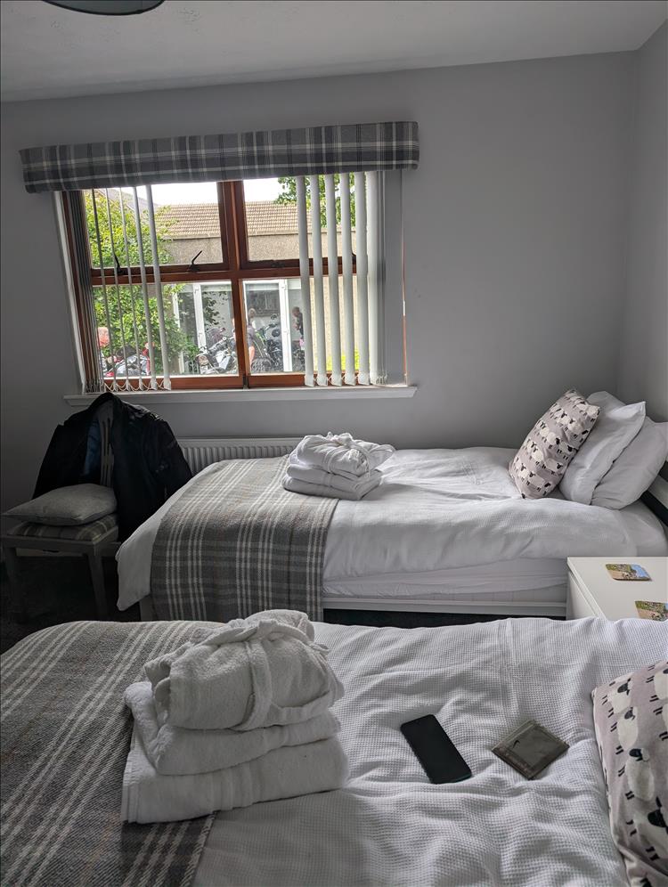 A twin room with a few sheep icons on the furniture etc