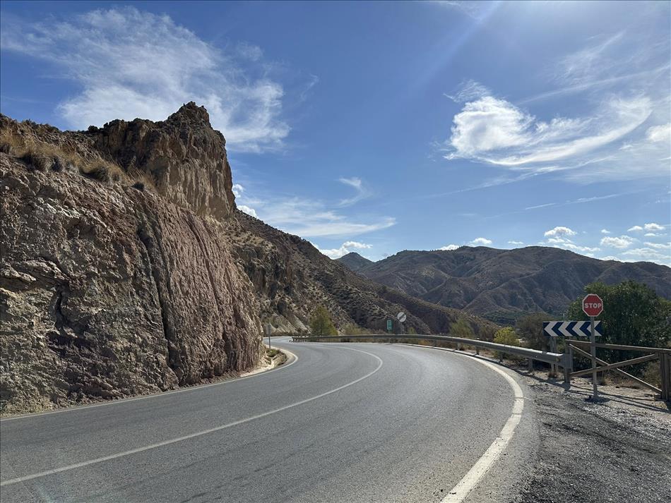 Another curve, more barriers, this time jagged hillsies and dry peaks beside the road
