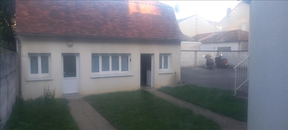 A small holiday let with a bit of grass and ample space for parking to the right