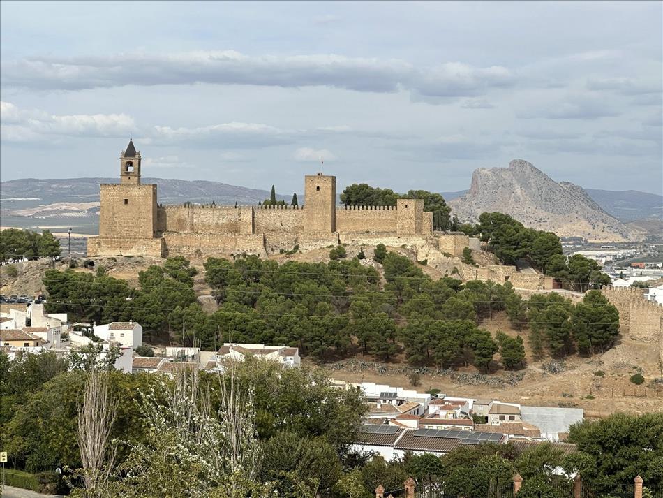 A large fort or building above a town, the building has crenellations