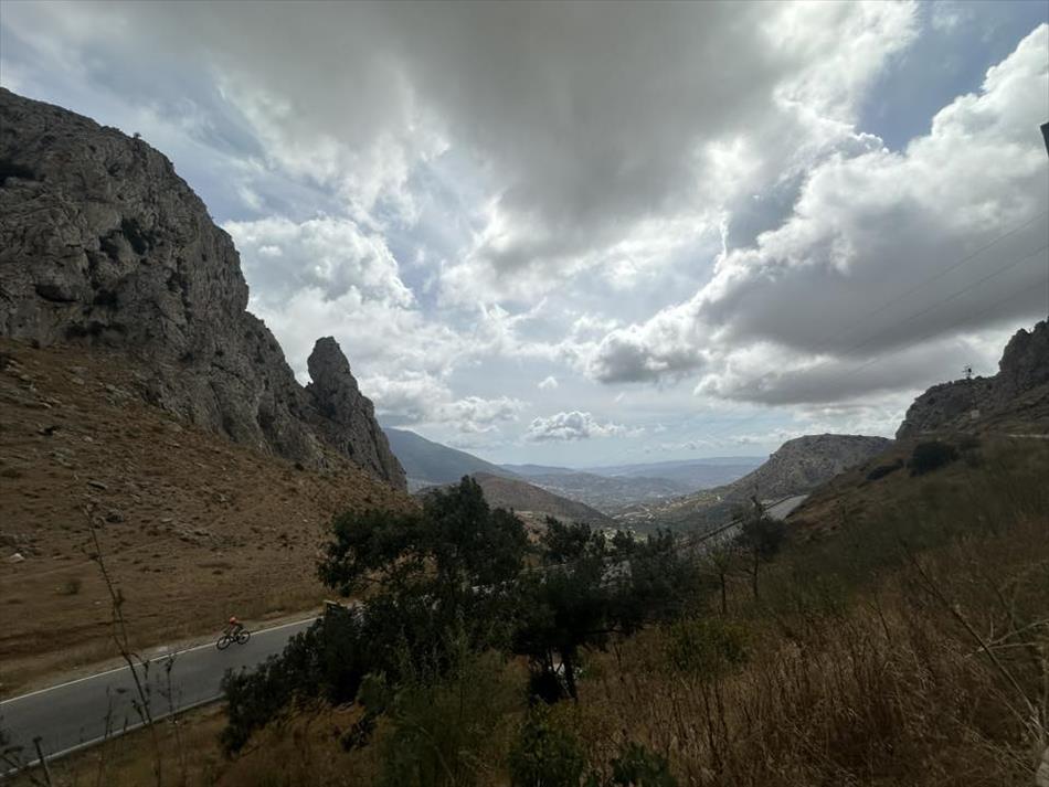 Between steep rocky sides the road heads down to more folds in the landscape and perhaps a town in the distance