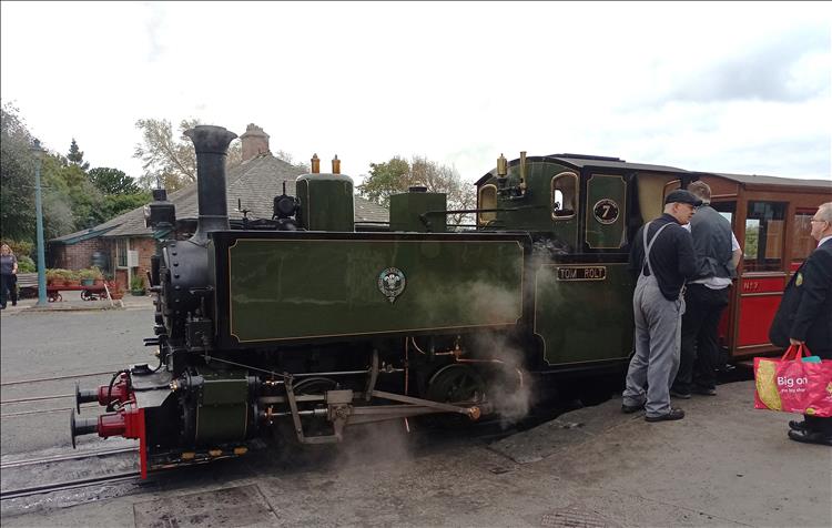 The old steam train, it's not big but it's steaming and hissing at the station