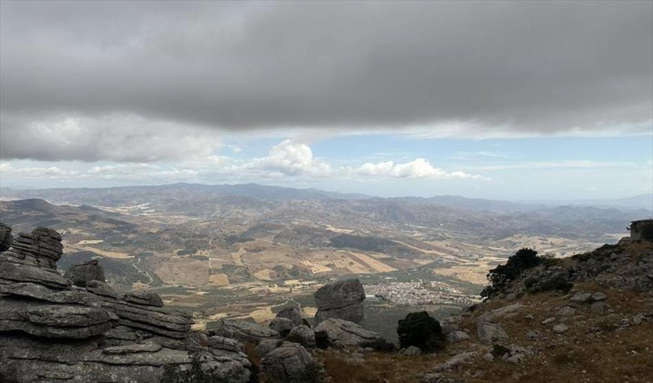 Looking between valley sides is a vast scene across Spain toward Malaga but it's behind hills