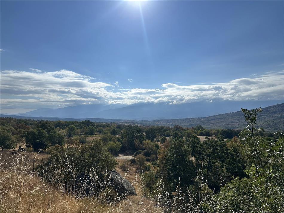 clear skies but in the distance moutains are topped my a layer of clouds