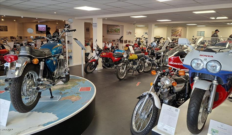 Very shiny Honda motorcycles across the years in a smart museum