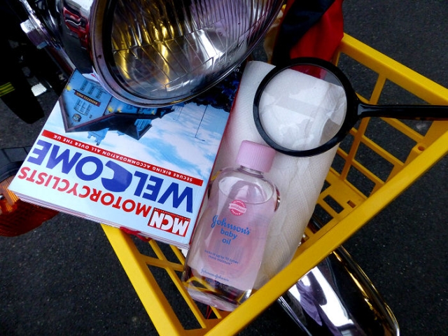 items in a basket mounted to the front of a motorbike