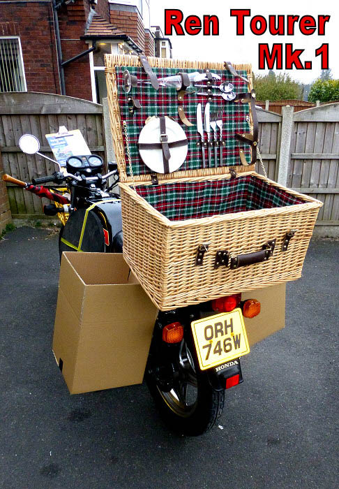 motorcycle with classic picnic basket on the back and cardboard boxes for panniers