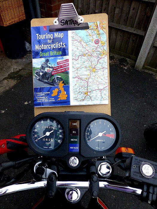 clipboard with map attached to clocks on a motorbike