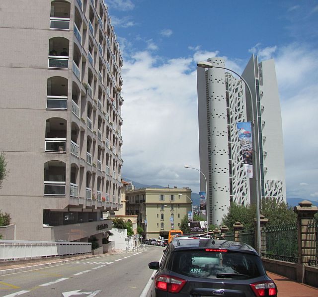 concrete apartments and trendy tall buildings and a line of traffic in Monaco