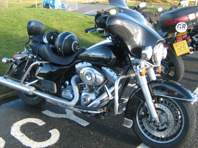 harley davidson cruiser and touring motorcycle in a car park