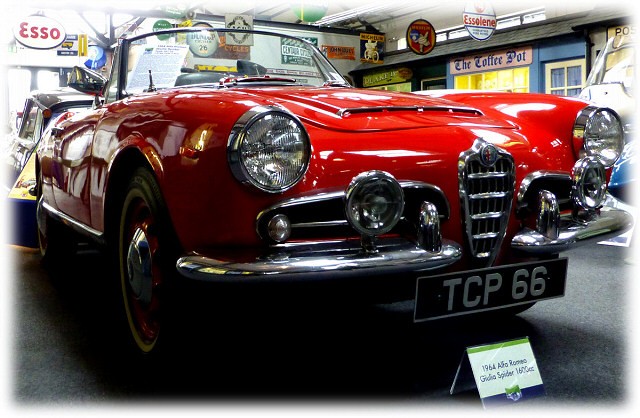the front of a bright red classic alfa romeo