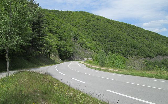 tree covered hills and twisting road winding through it on the d999