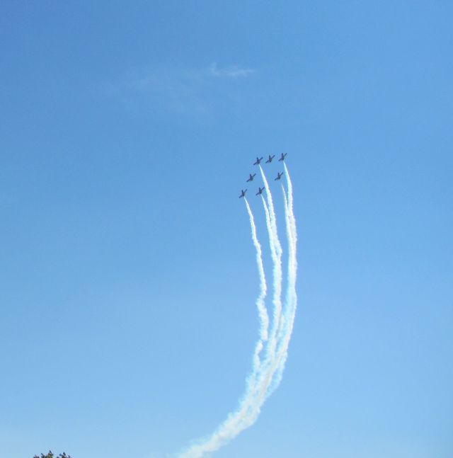 7 jets making smoke trails very high in the blue skies at salon de provence