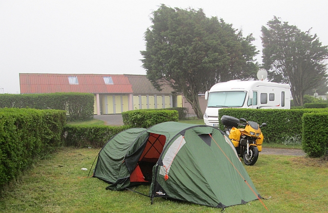 the fazer with side bags and the tent under a grey sky in the rain