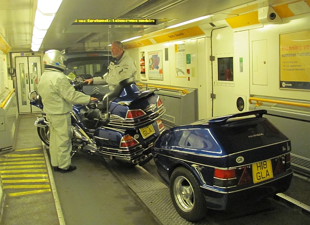 a honda gold wing with riders and trailer in the channel tunnel train