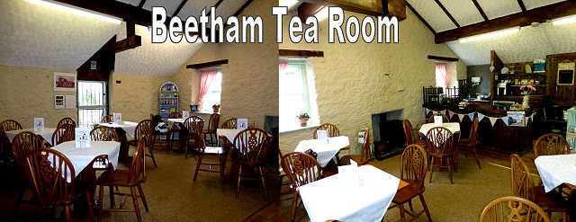 view inside the tea rooms at beetham, wooden chairs and tables with cloths in a whitewashed stone room