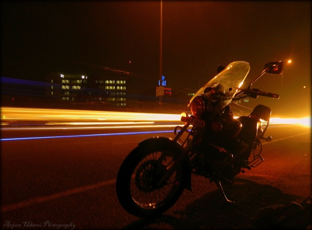 motorcycle in the dark with streaks of light behind