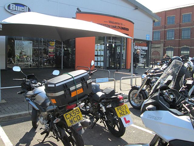 sharon's 125 parked smarty inline next to the bf's bike outside the harley davidson shop preston