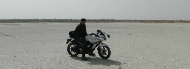 biker posing on the salt flats