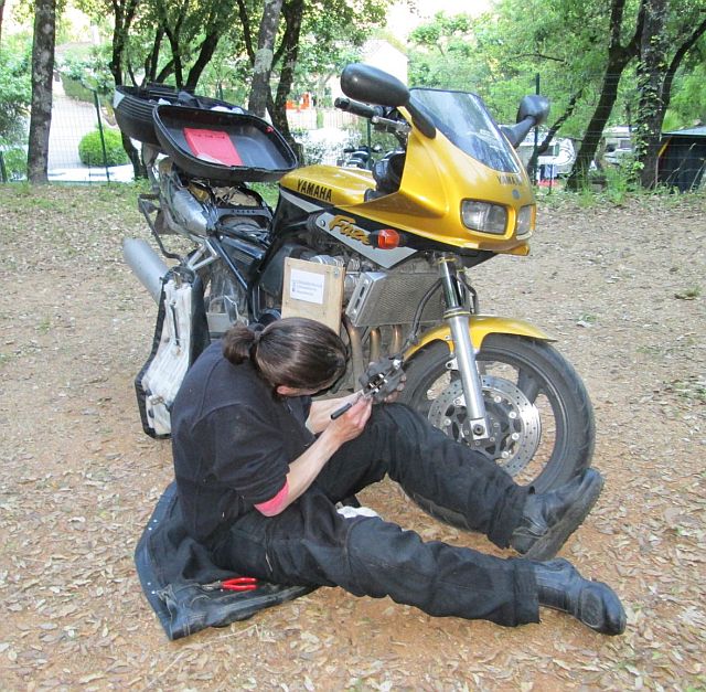 the bf sat on the floor with the front brake in bits and getting all dirty at the campsite